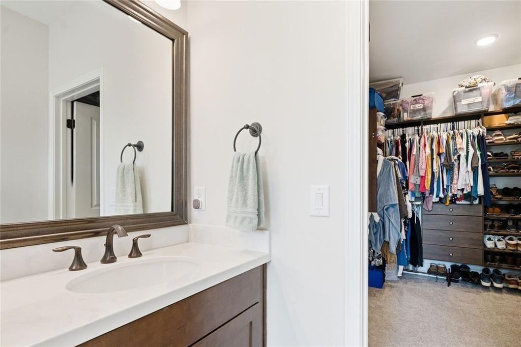 328 McQueen Way Canton, GA 30115 - Photo 36 of 66 a bathroom with a sink and a mirror