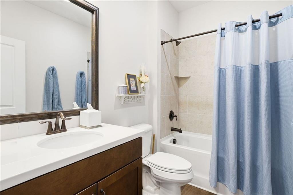 328 McQueen Way Canton, GA 30115 - Photo 40 of 66 a bathroom with a sink a toilet and a mirror