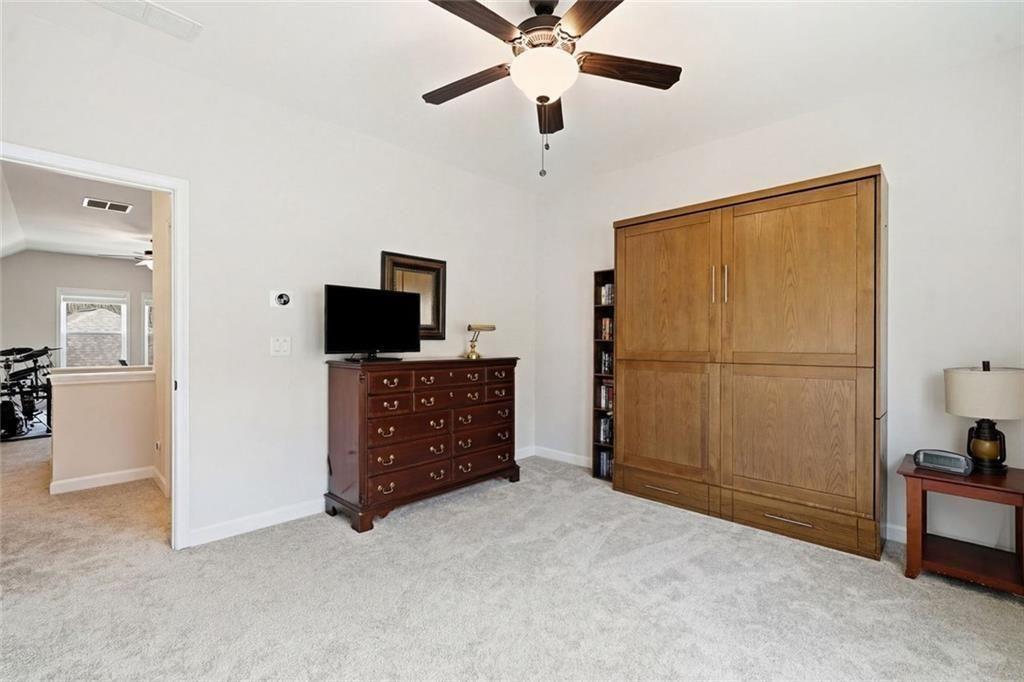 328 McQueen Way Canton, GA 30115 - Photo 42 of 66 a view of a livingroom with furniture and a flat screen tv