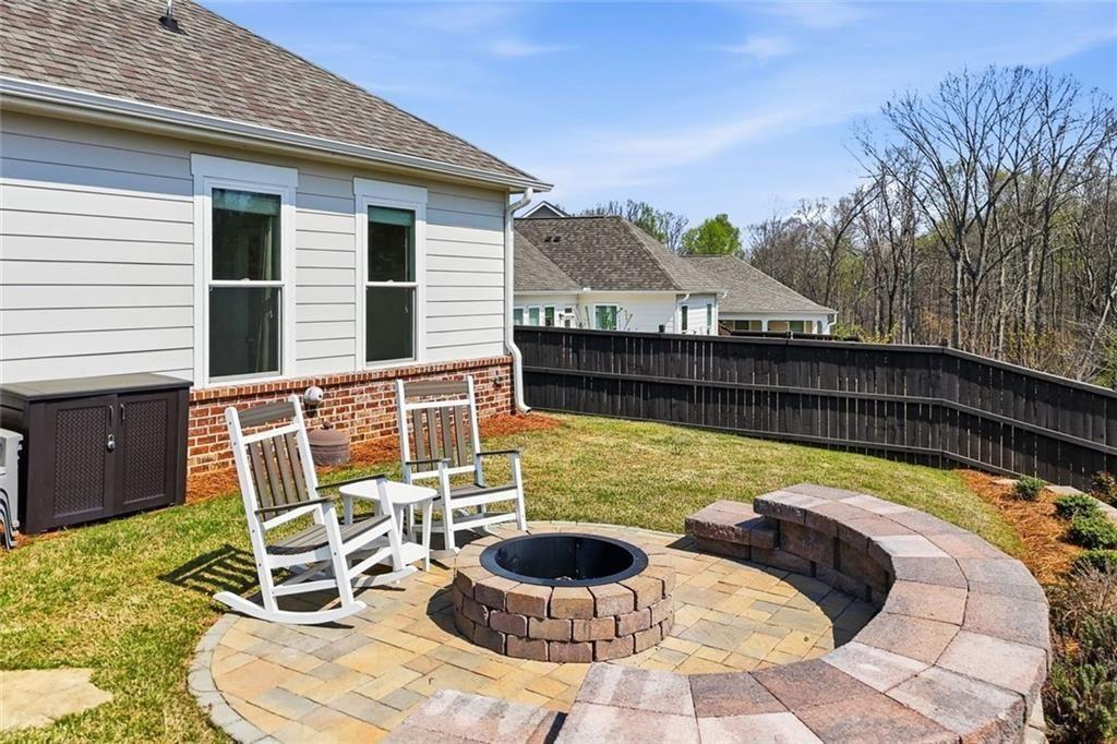 328 McQueen Way Canton, GA 30115 - Photo 47 of 66 a view of a balcony with chair and a potted plant