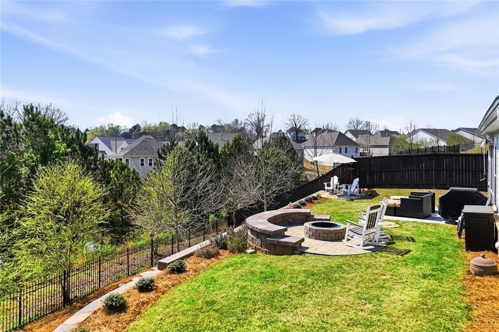 328 McQueen Way Canton, GA 30115 - Photo 48 of 66 a view of a swimming pool with a yard and furniture