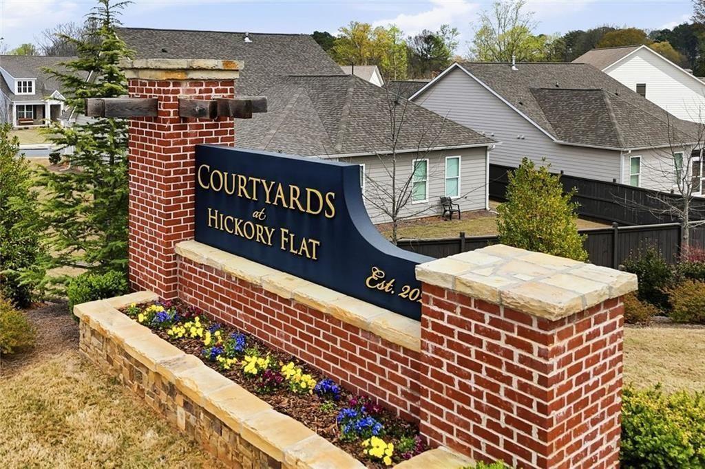 328 McQueen Way Canton, GA 30115 - Photo 58 of 66 a sign that is on a brick wall