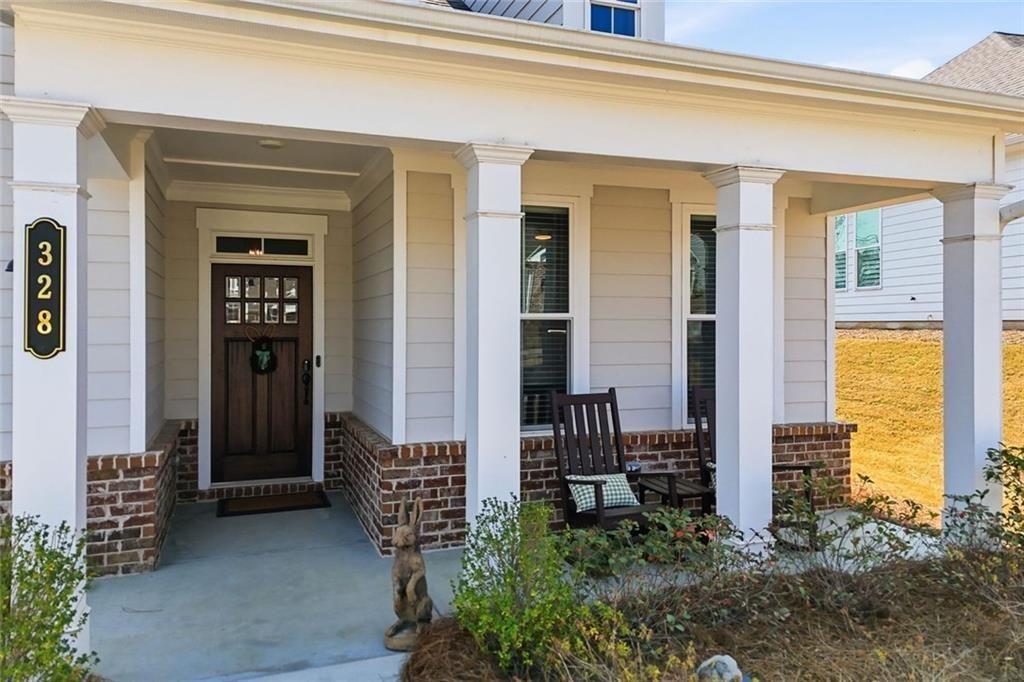 328 McQueen Way Canton, GA 30115 - Photo 6 of 66 a front view of a house with a garden
