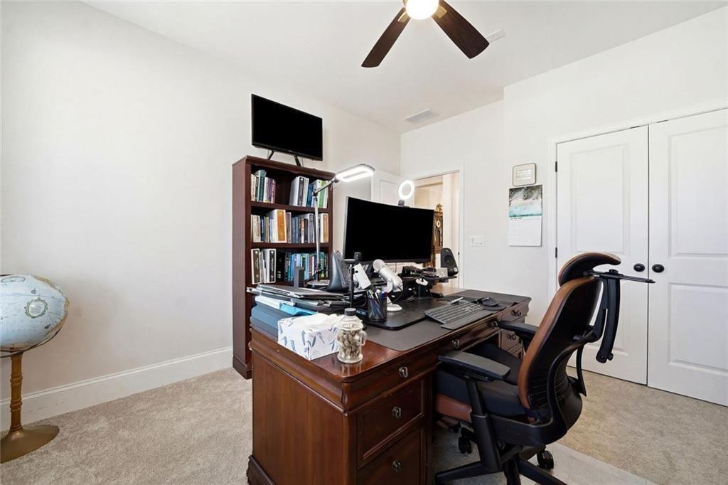 328 McQueen Way Canton, GA 30115 - Photo 10 of 66 a view of a workspace with furniture and a flat screen tv