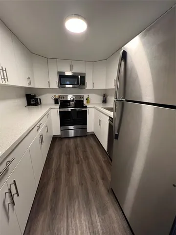 a kitchen with stainless steel appliances a refrigerator sink and stove
