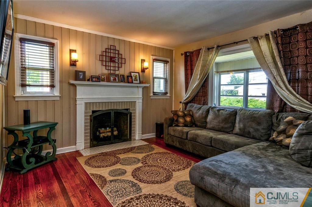 988 Clark Road North Brunswick, NJ 08902 - Photo 2 of 25 a living room with furniture and a fireplace