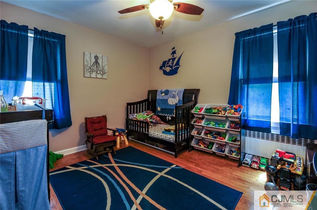 988 Clark Road North Brunswick, NJ 08902 - Photo 12 of 25 a room with furniture and wooden floor