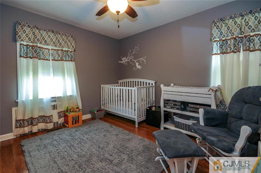 988 Clark Road North Brunswick, NJ 08902 - Photo 14 of 25 a view of a livingroom with furniture and a ceiling fan