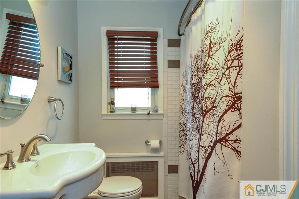 988 Clark Road North Brunswick, NJ 08902 - Photo 15 of 25 a bathroom with a toilet sink and mirror