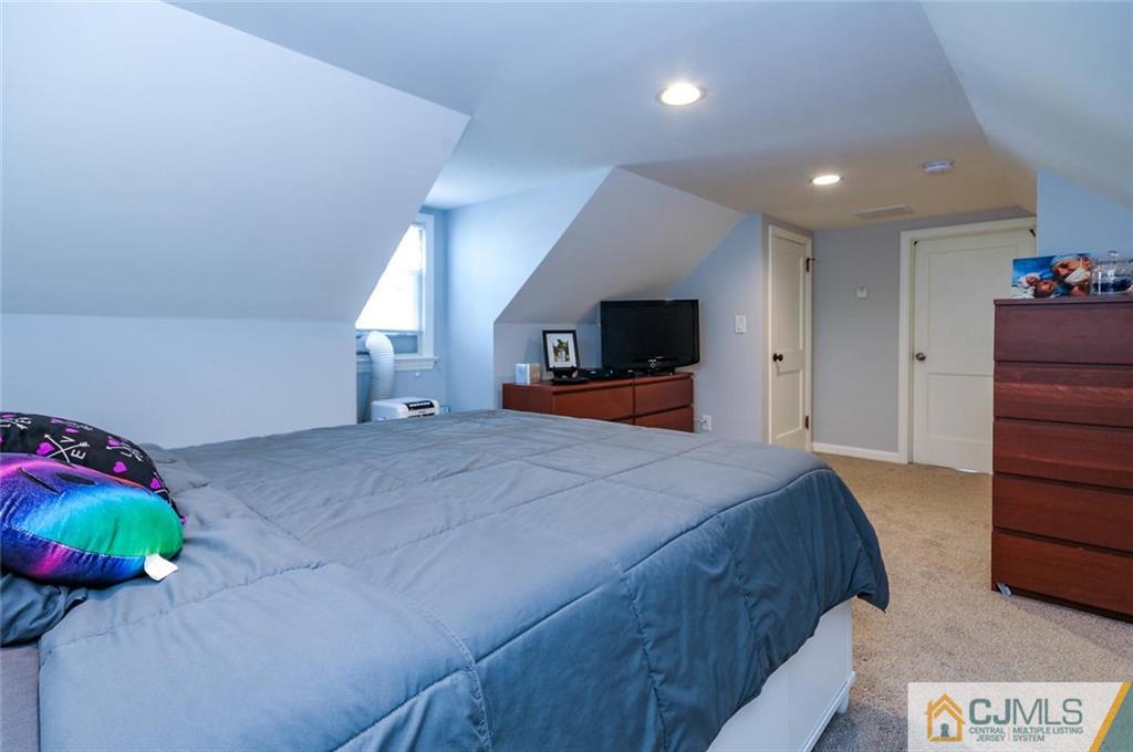 988 Clark Road North Brunswick, NJ 08902 - Photo 18 of 25 a bedroom with a bed and a television