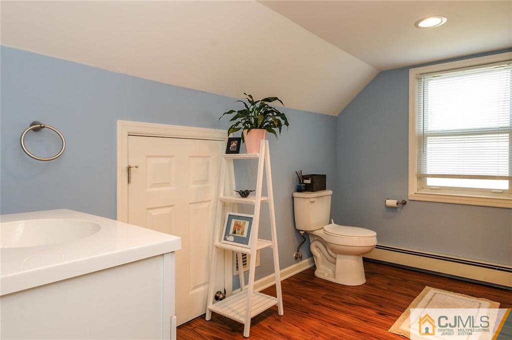 988 Clark Road North Brunswick, NJ 08902 - Photo 19 of 25 a bathroom with a sink toilet and window