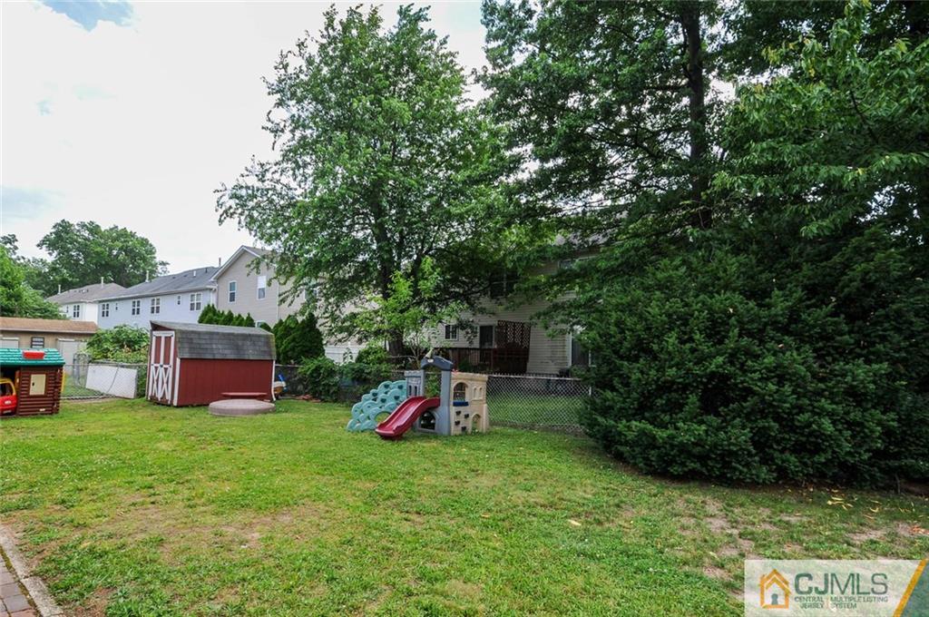 988 Clark Road North Brunswick, NJ 08902 - Photo 25 of 25 a view of a chair and table in backyard of the house