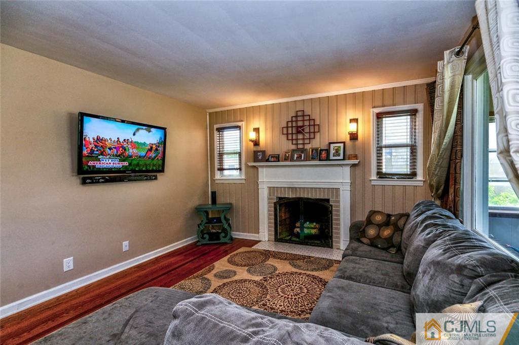 988 Clark Road North Brunswick, NJ 08902 - Photo 4 of 25 a living room with furniture and a fireplace