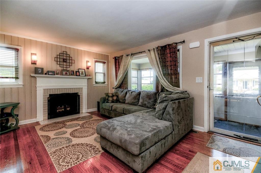988 Clark Road North Brunswick, NJ 08902 - Photo 5 of 25 a living room with furniture and a fireplace