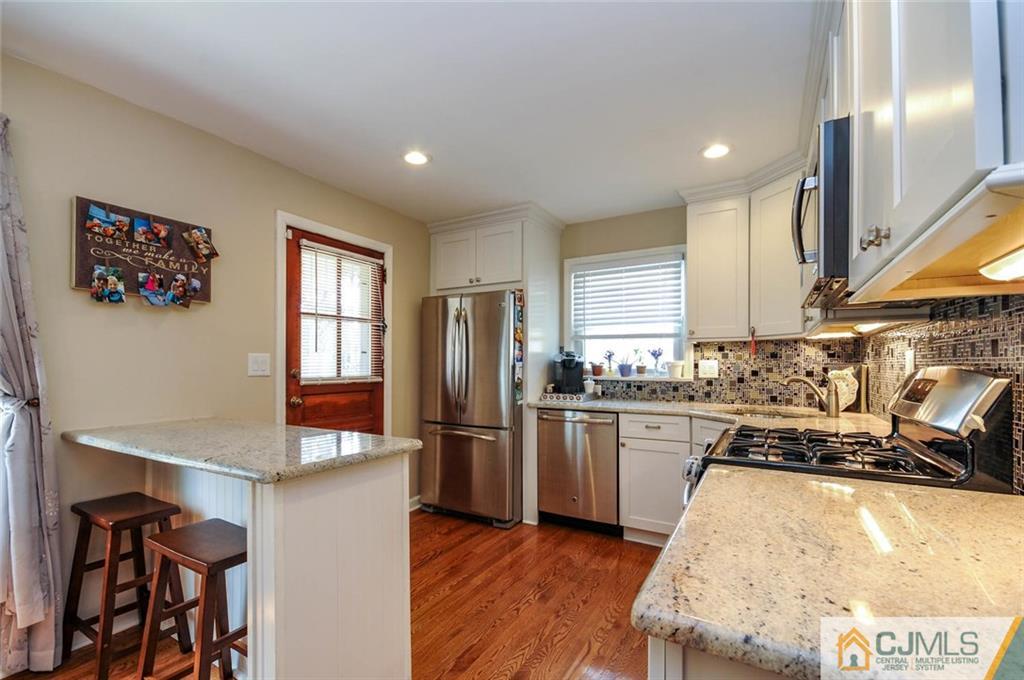 988 Clark Road North Brunswick, NJ 08902 - Photo 6 of 25 a kitchen with stainless steel appliances granite countertop a refrigerator and a stove top oven