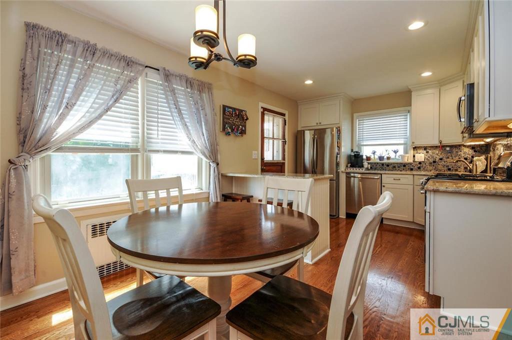 988 Clark Road North Brunswick, NJ 08902 - Photo 10 of 25 a dining room with furniture a chandelier and window