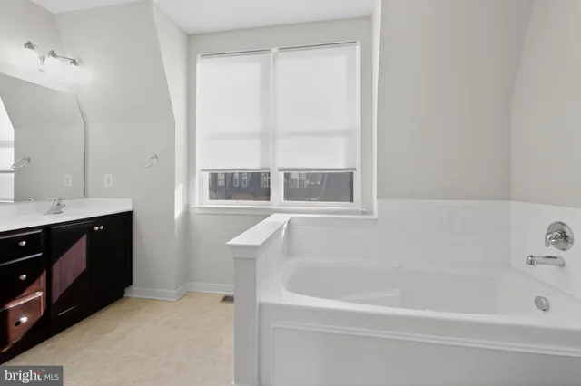 a bathroom with a bathtub and a sink