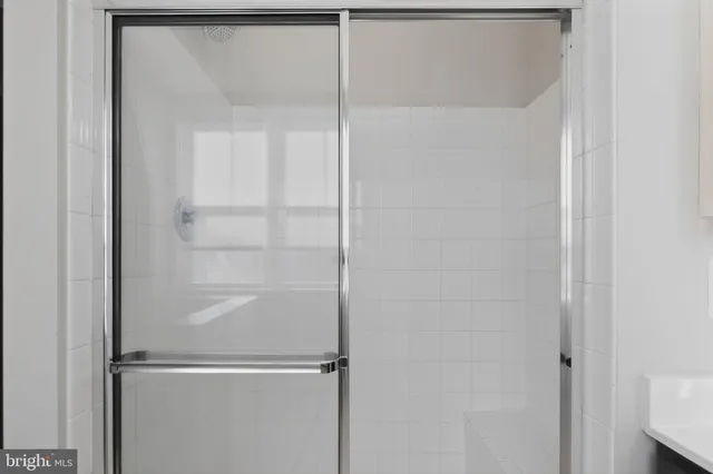 a bathroom with a glass shower door