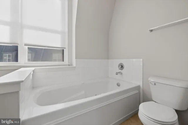 a white bath tub sitting next to a white toilet