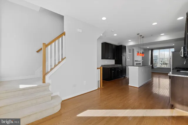 a view of a living room with kitchen furniture and a flat screen tv