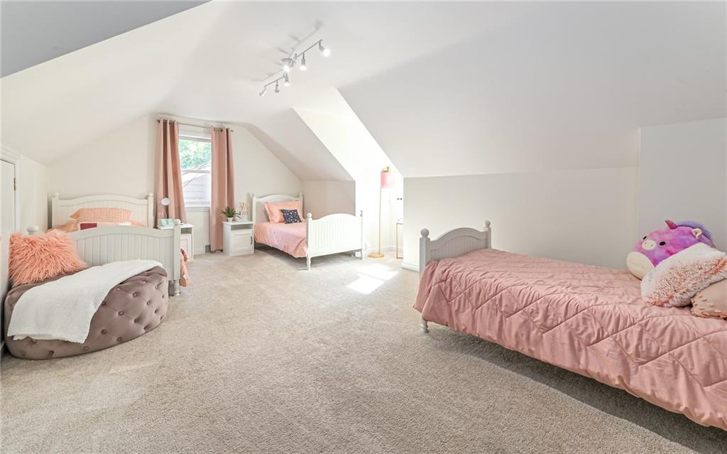 511 Chestnut Road Sewickley, PA 15143 - Photo 14 of 25 a spacious bedroom with a bed and a chandelier