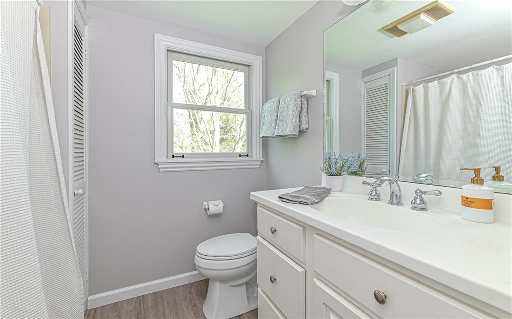 511 Chestnut Road Sewickley, PA 15143 - Photo 17 of 25 a bathroom with a sink a toilet and a window