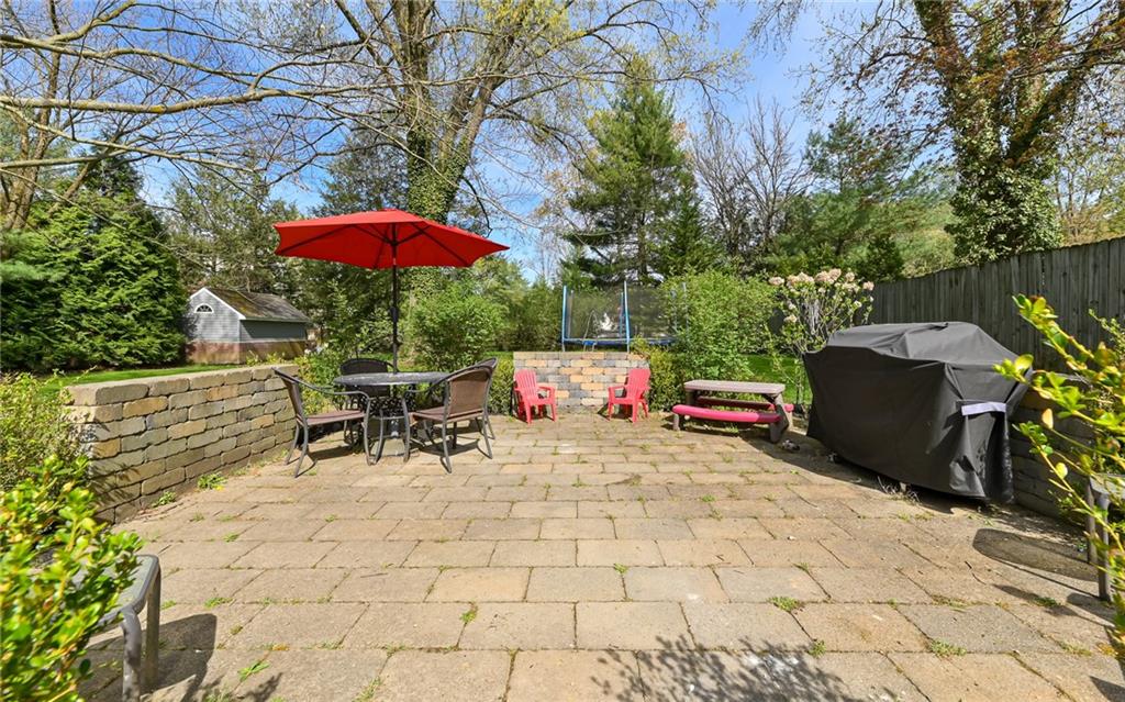 511 Chestnut Road Sewickley, PA 15143 - Photo 21 of 25 a view of a patio with a table and chairs under an umbrella