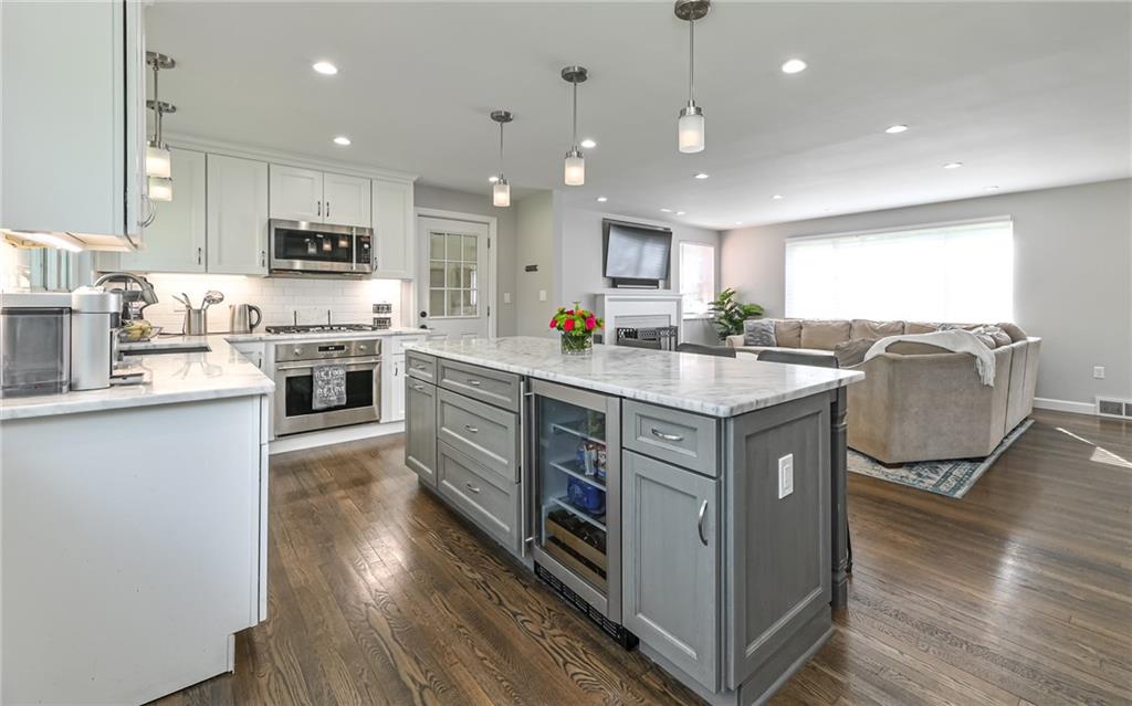 511 Chestnut Road Sewickley, PA 15143 - Photo 4 of 25 a kitchen with stainless steel appliances granite countertop a stove top oven a sink dishwasher and a refrigerator with wooden floor