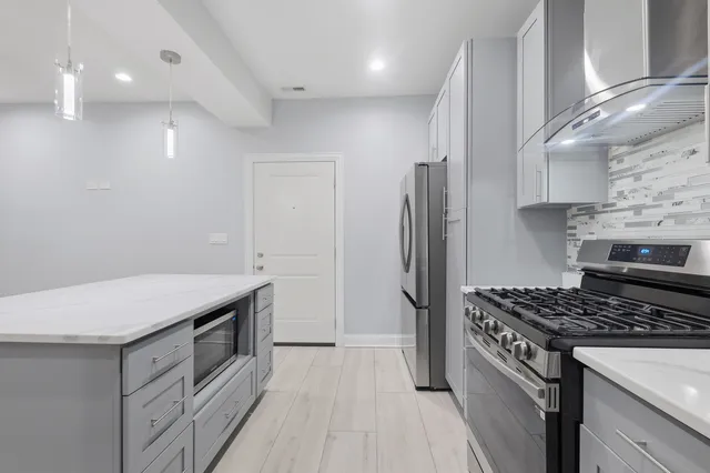 a kitchen with a stove a sink and a refrigerator