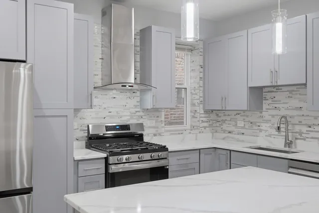 a kitchen with stainless steel appliances stove a sink and cabinets