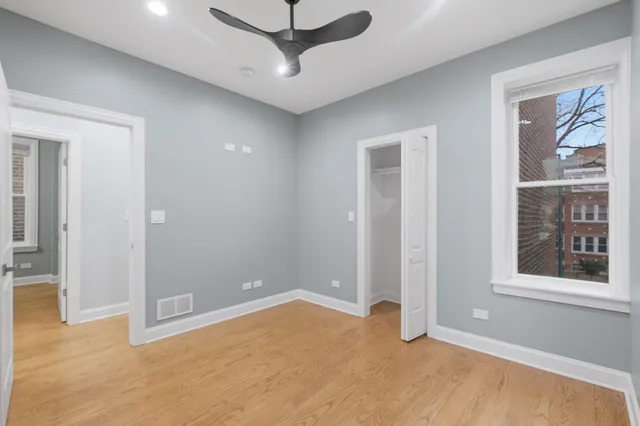 an empty room with windows and closet