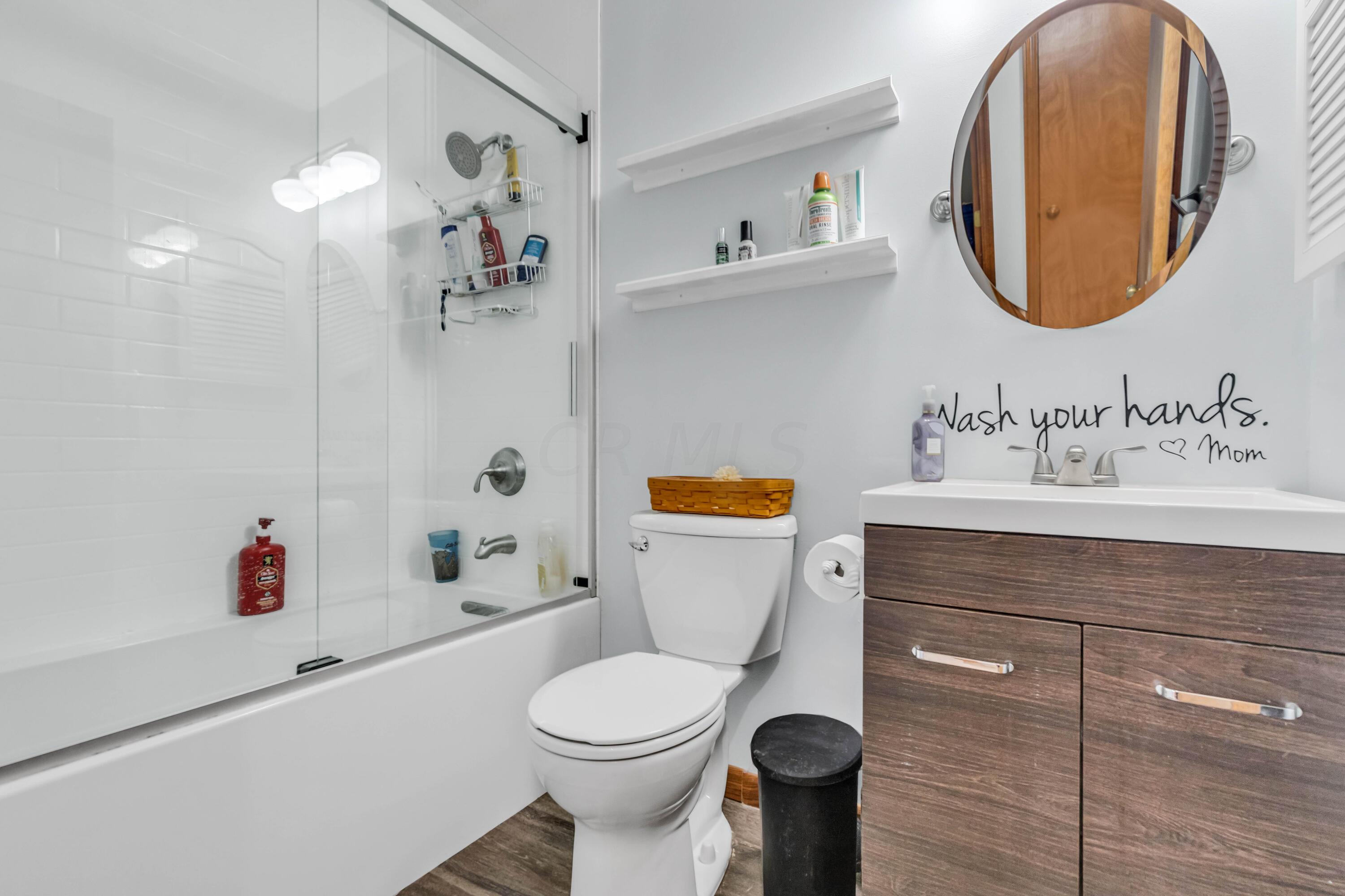 435 Emory Street Gahanna, OH 43230 - Photo 31 of 54 • New luxury vinyl plank
flooring
• Blue painted walls
• Ceiling exhaust
• Tub/shower combination
with glass doors
• Enclosed vanity with
single bowl, cultured marble
sinktop
• 3 bulb wall light
• Medicine cabinet
• Wall mirror
• Wall shelves stay