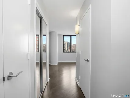 a view of a hallway with wooden floor