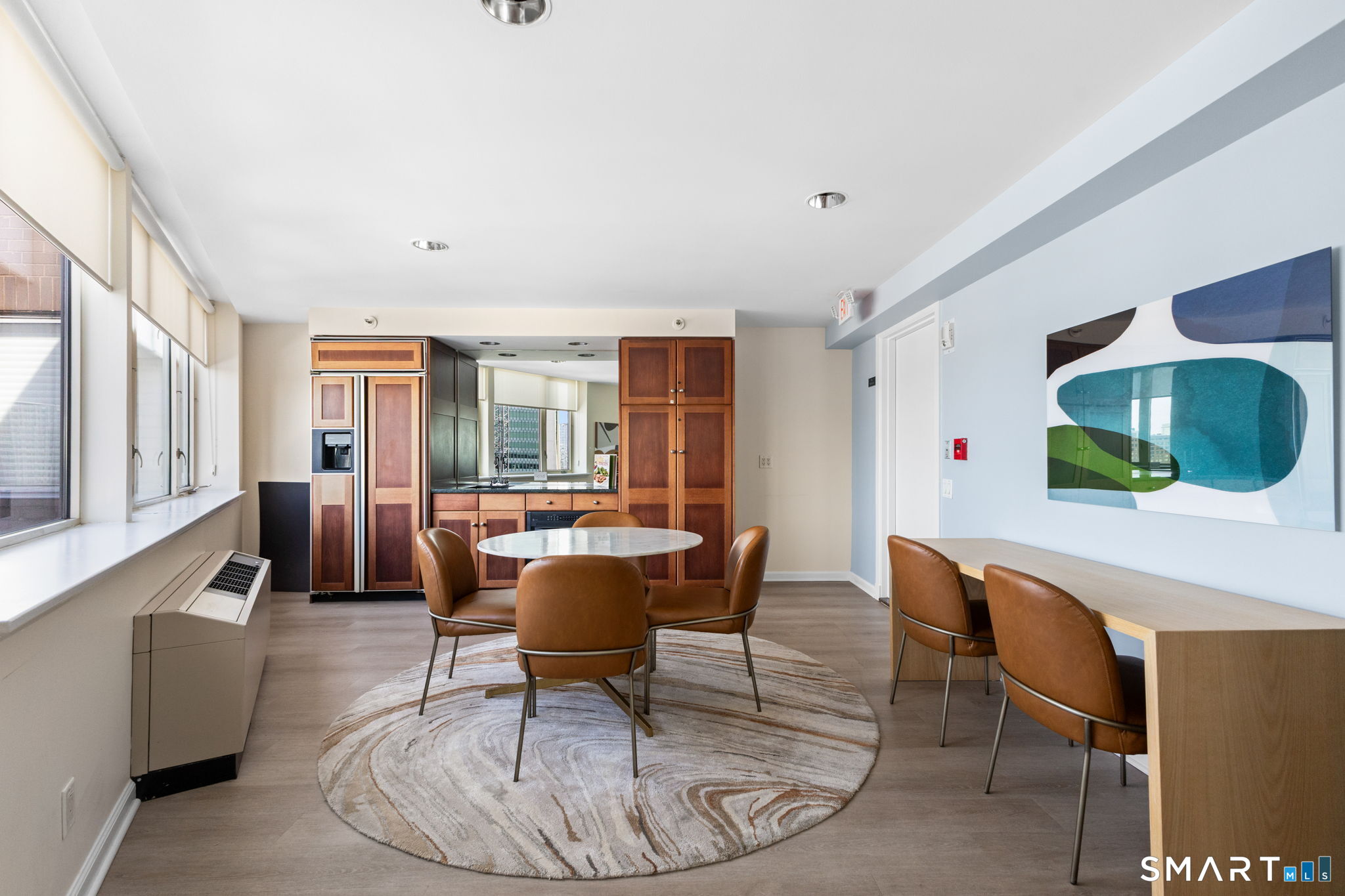 25 Forest Street, Unit 7D Stamford, CT 06901 - Photo 23 of 33 a living room with furniture a dining table and chairs