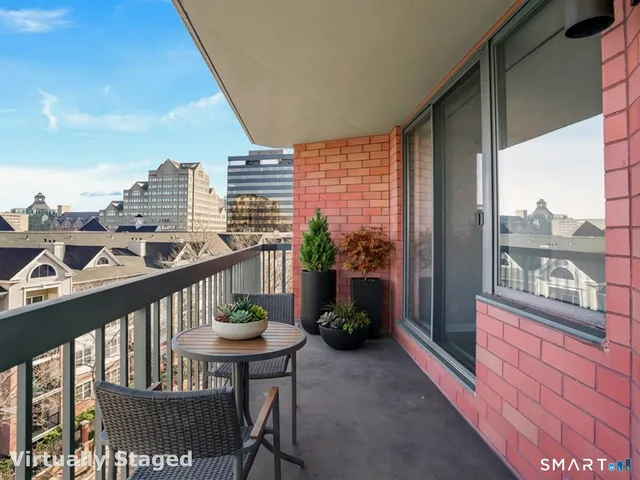 a view of a balcony with chairs and a table