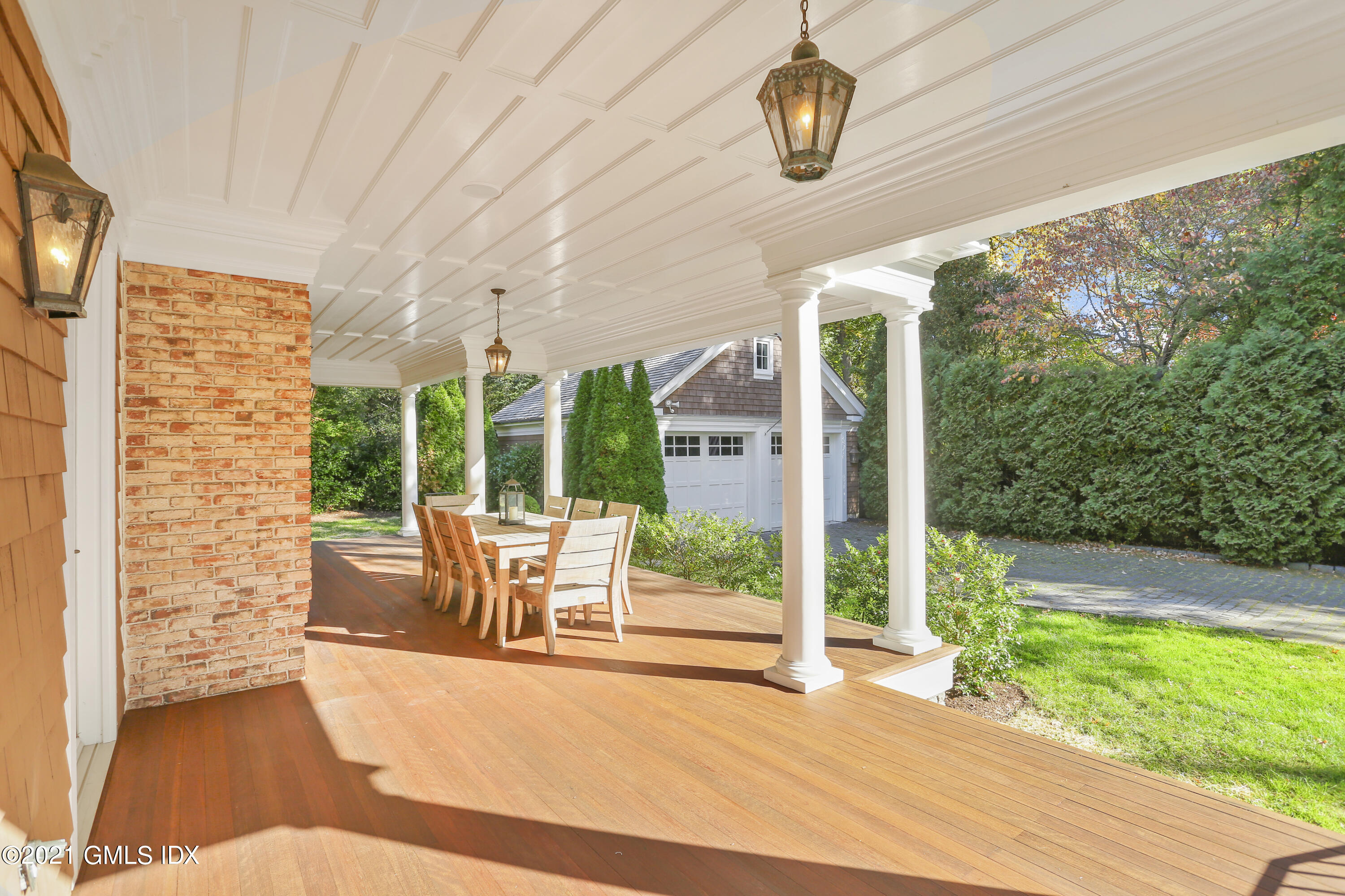 222 Riverside Avenue Riverside, CT 06878 - Photo 51 of 61 a view of a patio with table and chairs potted plants with wooden floor