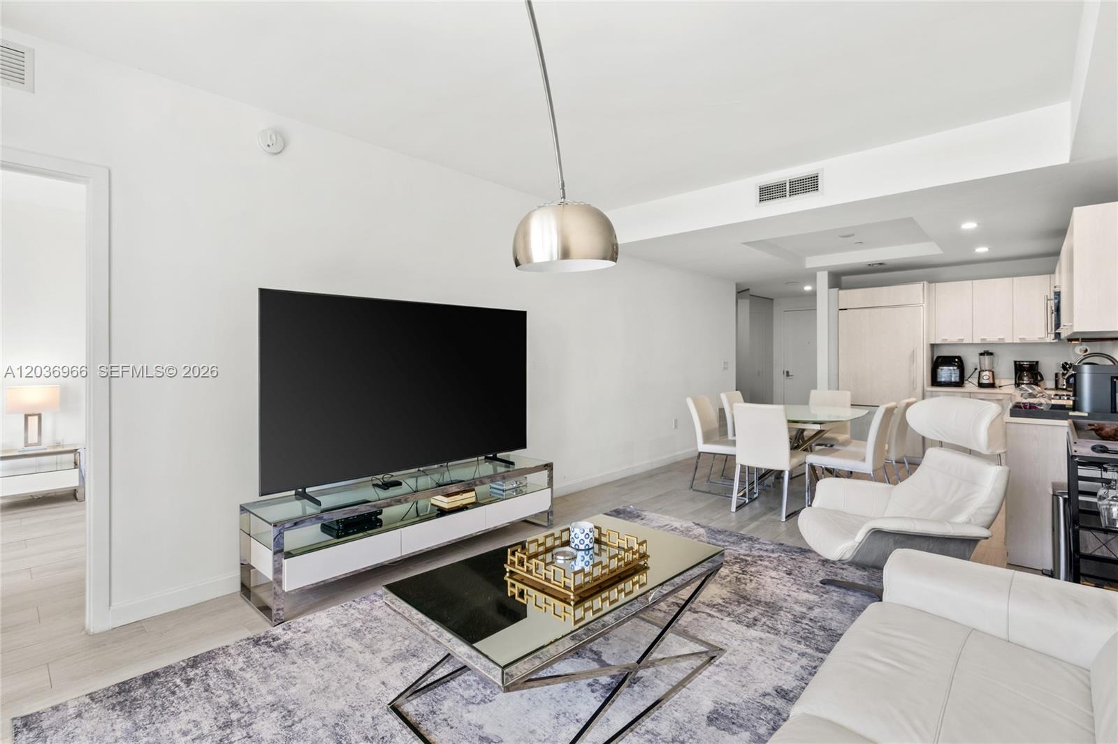 55 Southwest 9th Street, Unit 1904 Miami, FL 33130 - Photo 15 of 66 a living room with furniture and a flat screen tv