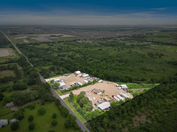 an aerial view of a houses with a yard