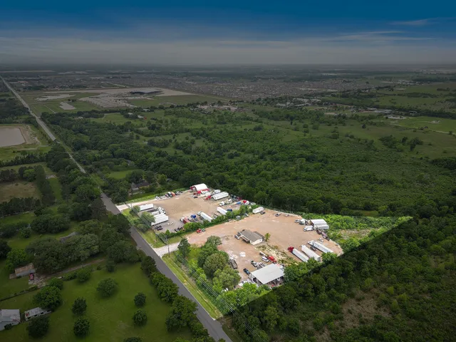 an aerial view of a houses with a yard