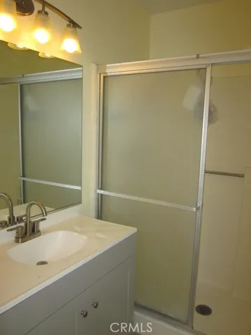 a white toilet sitting next to a shower