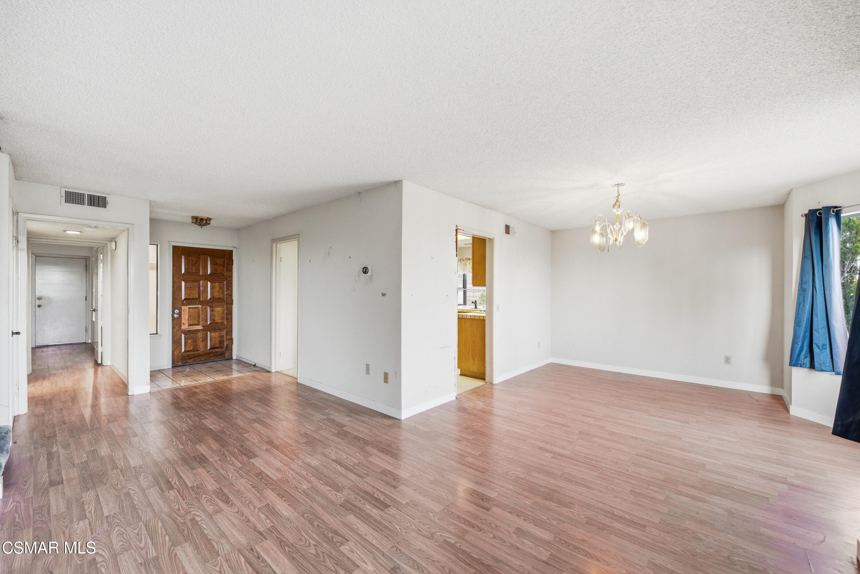 12036 Shadow Ridge Way Porter Ranch, CA 91326 - Photo 5 of 35 a view of an empty room with window and wooden floor