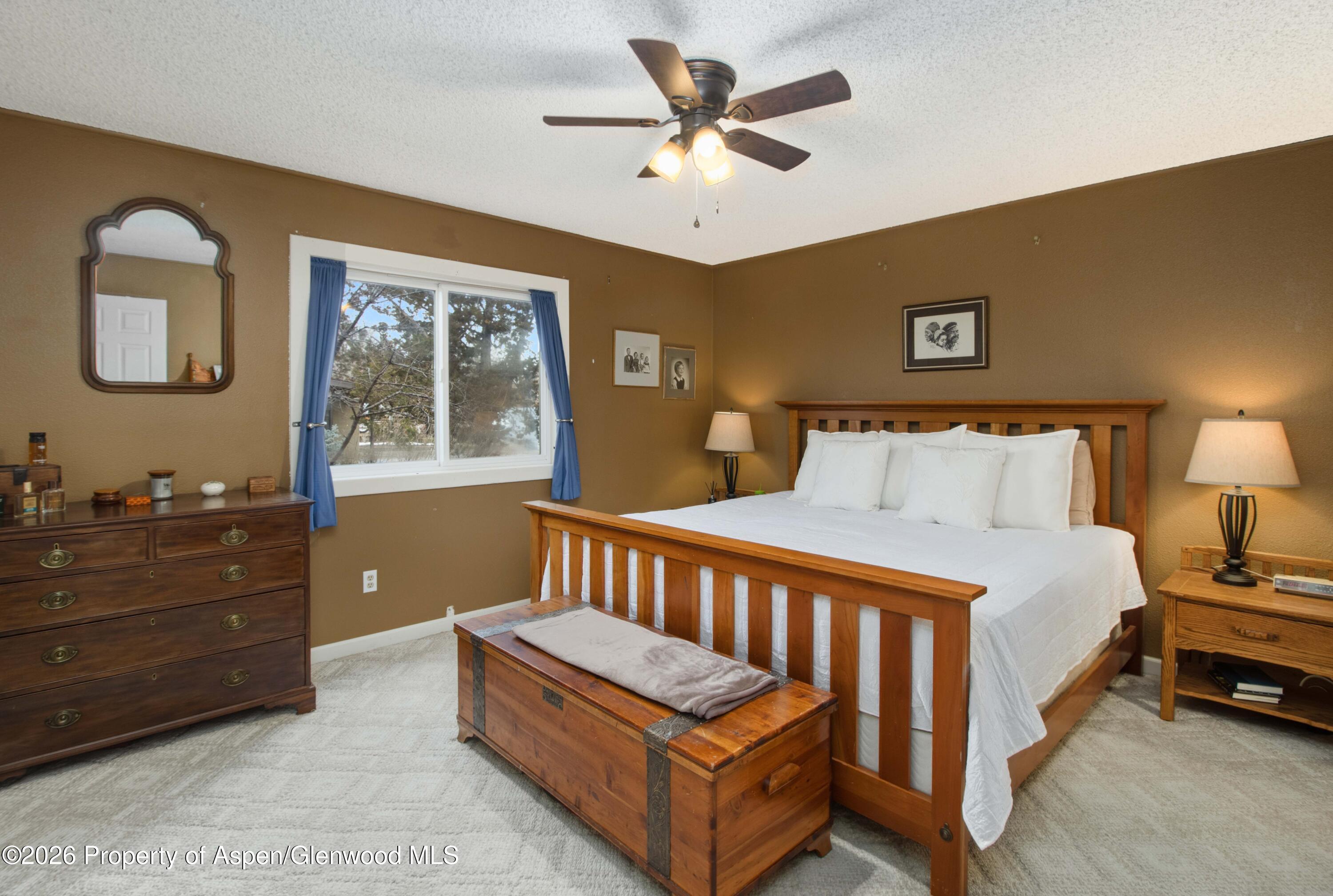 1441 Jays Avenue Rifle, CO 81650 - Photo 11 of 28 a bedroom with a bed and a dresser