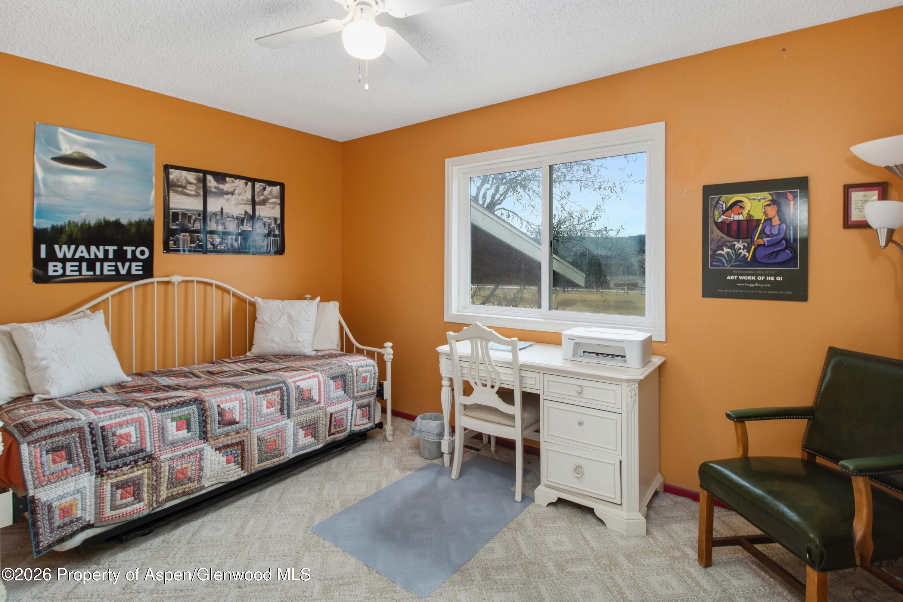 1441 Jays Avenue Rifle, CO 81650 - Photo 13 of 28 a bedroom with a bed and a desk