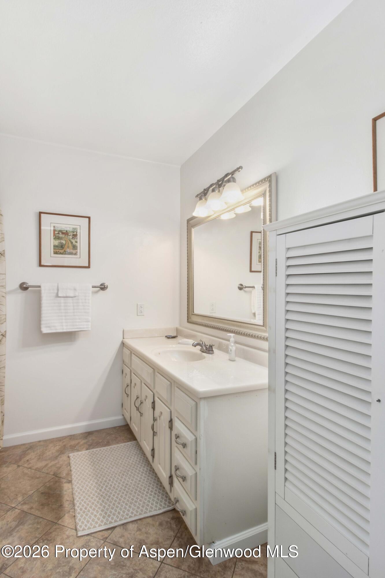 1441 Jays Avenue Rifle, CO 81650 - Photo 16 of 28 a bathroom with a sink a toilet and mirror