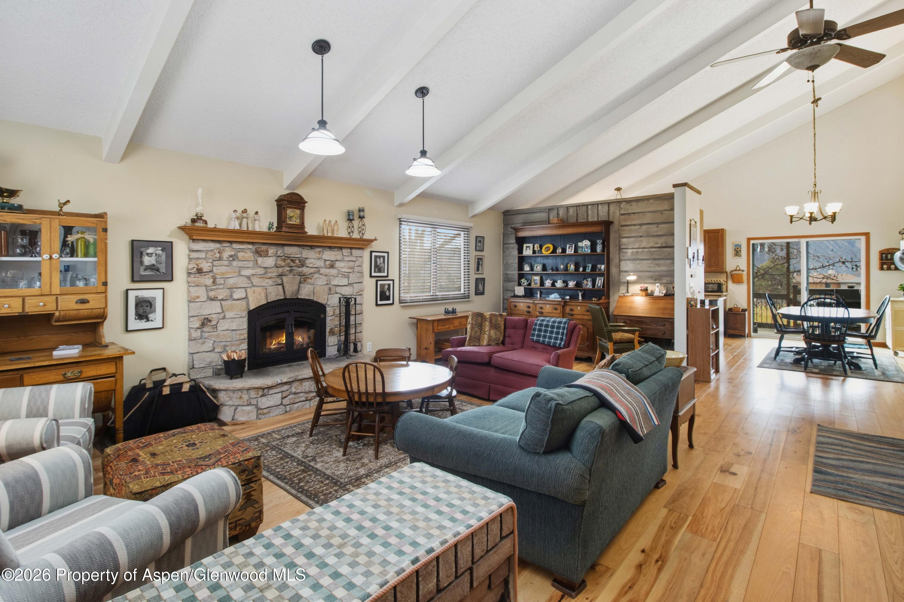 1441 Jays Avenue Rifle, CO 81650 - Photo 3 of 28 a living room with furniture a fireplace and a chandelier