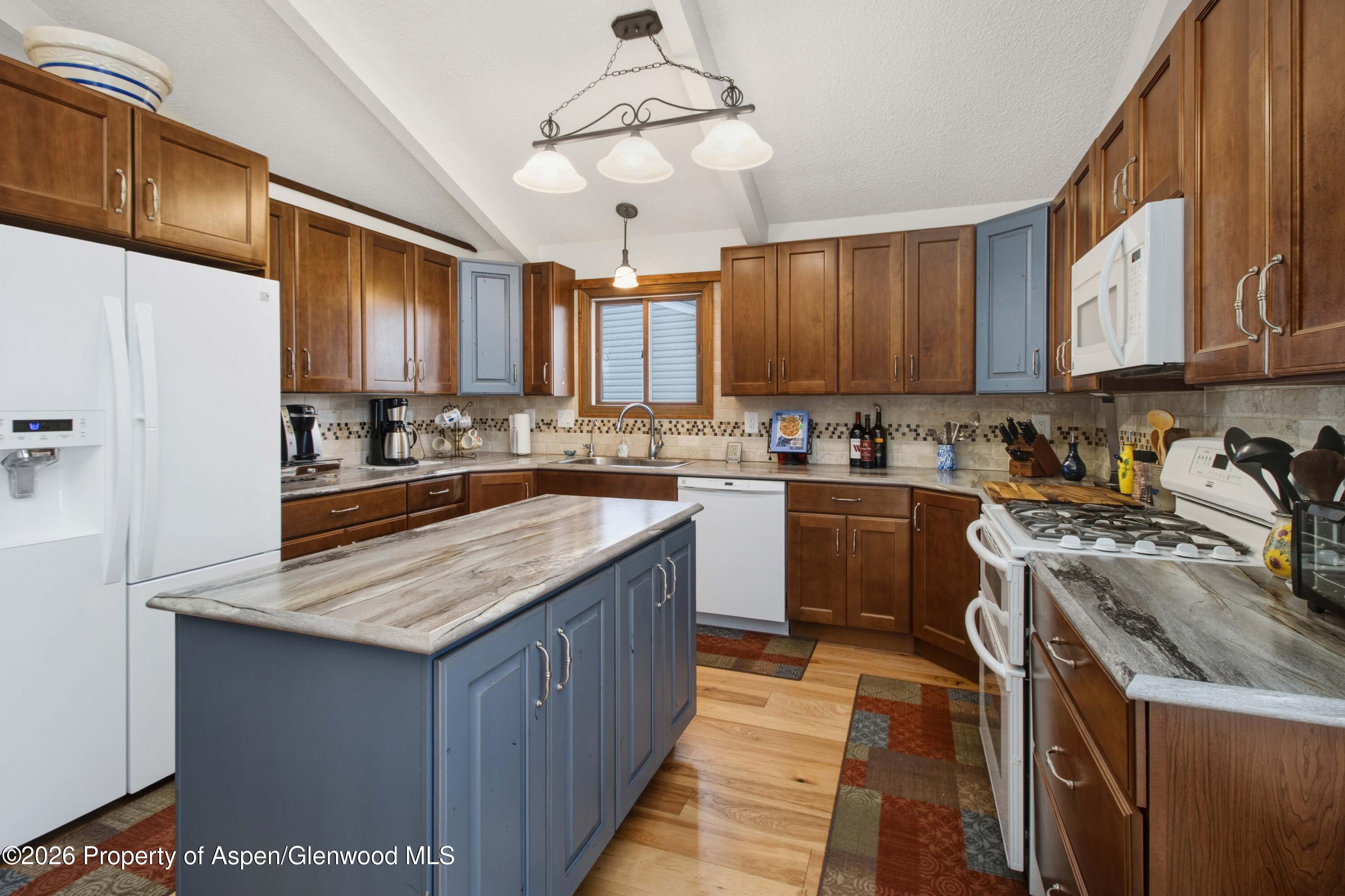 1441 Jays Avenue Rifle, CO 81650 - Photo 7 of 28 a kitchen with a stove sink cabinets and window