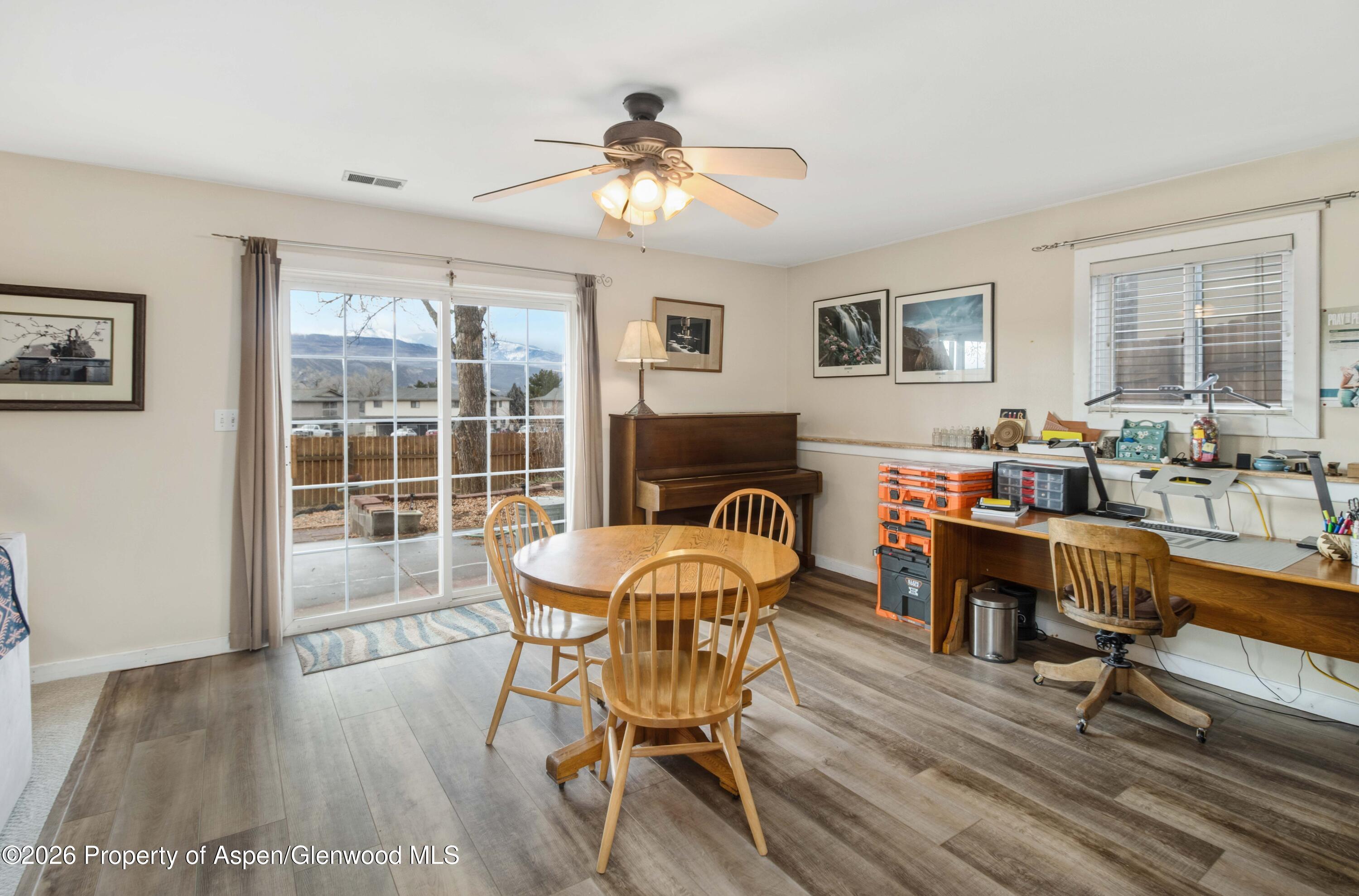 1441 Jays Avenue Rifle, CO 81650 - Photo 10 of 28 a dining room with furniture a window and wooden floor