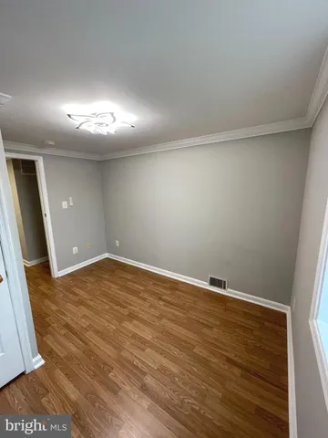 an empty room with wooden floor