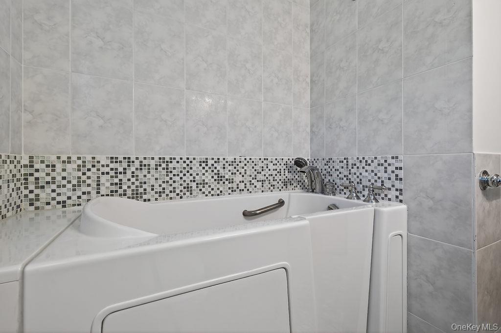 6 Winterberry Road Fishkill, NY 12524 - Photo 19 of 43 Walk-in tub with grab bar and chrome fixtures