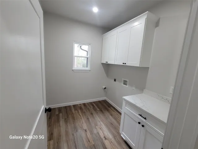 a view of storage and utility room with wooden floor